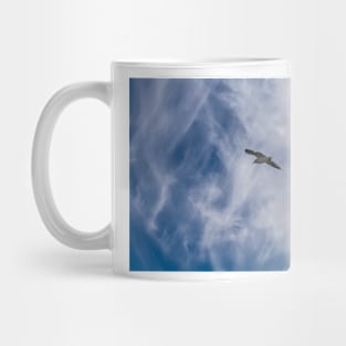 White seagull flying in bright blue sky Mug